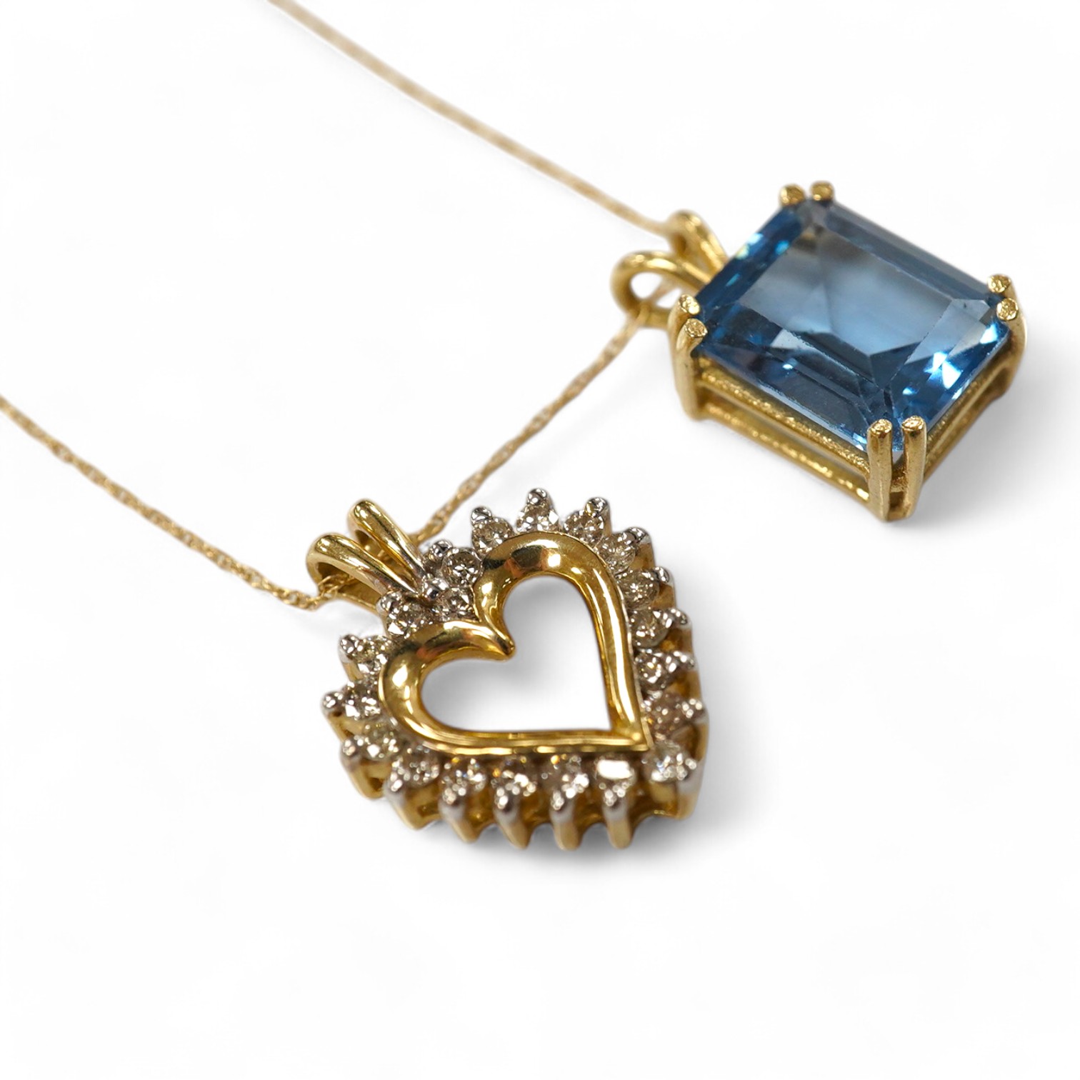 A modern 10K fine link chain, 46cm, together with a 10k and diamond set open heart shaped pendant, 21mm and a synthetic blue spinel pendant, gross weight 6.1 grams. Condition - fair to good